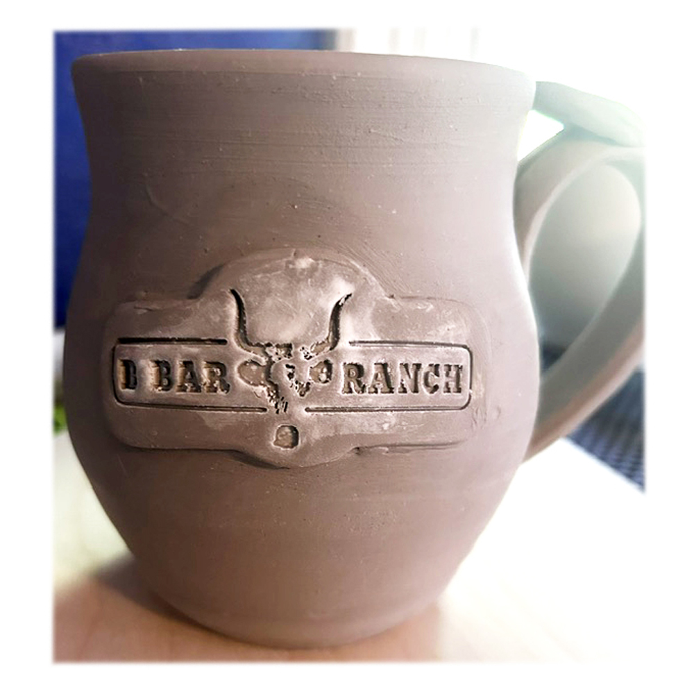 assembled mug and logo stamped clay piece